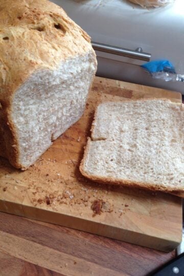 A delicious olive oil bread recipe displayed on a cutting board with a knife.