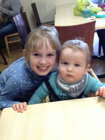 a lady, two little girls and one baby boy.