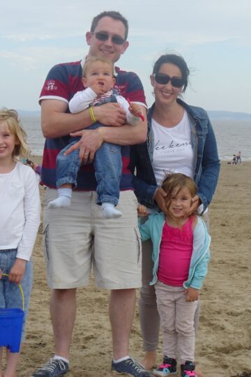 A group of my family and friends standing on a beach in July 2015.