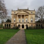 A grand mansion with a charming pathway in front, ideal for a luxurious weekend retreat in Bath.