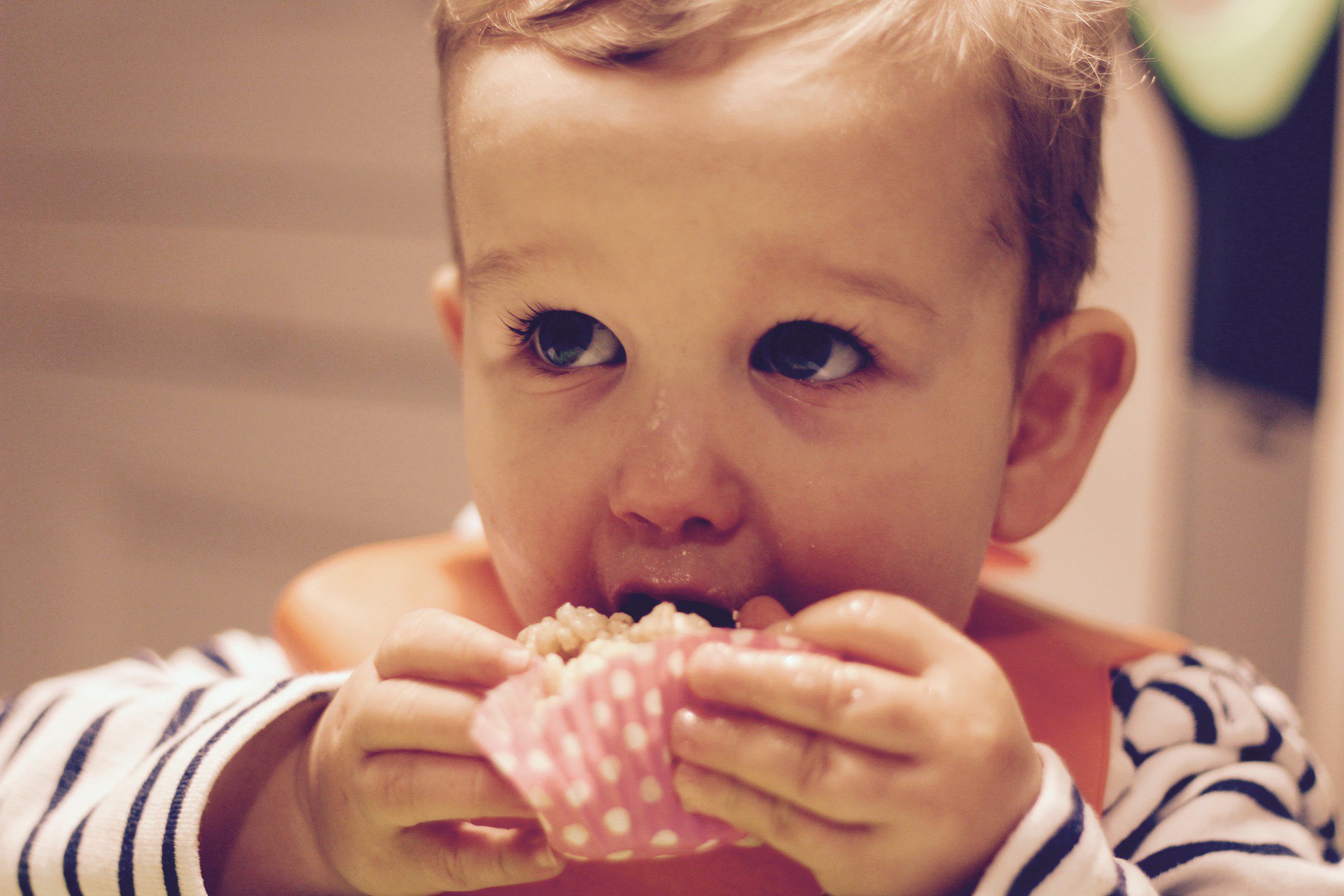 a young boy eating a White Chocolate White Crispy Cakes