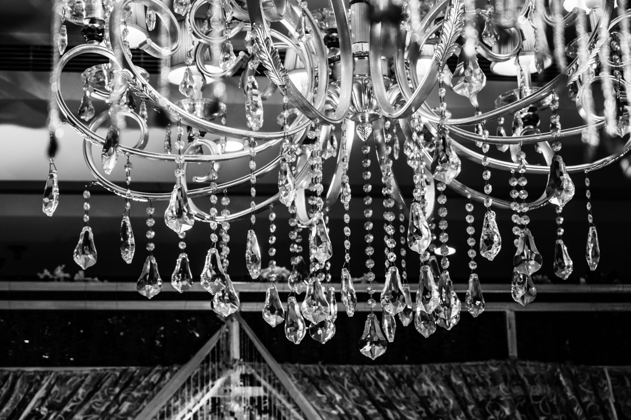 A stylish black and white photograph of a chandelier.