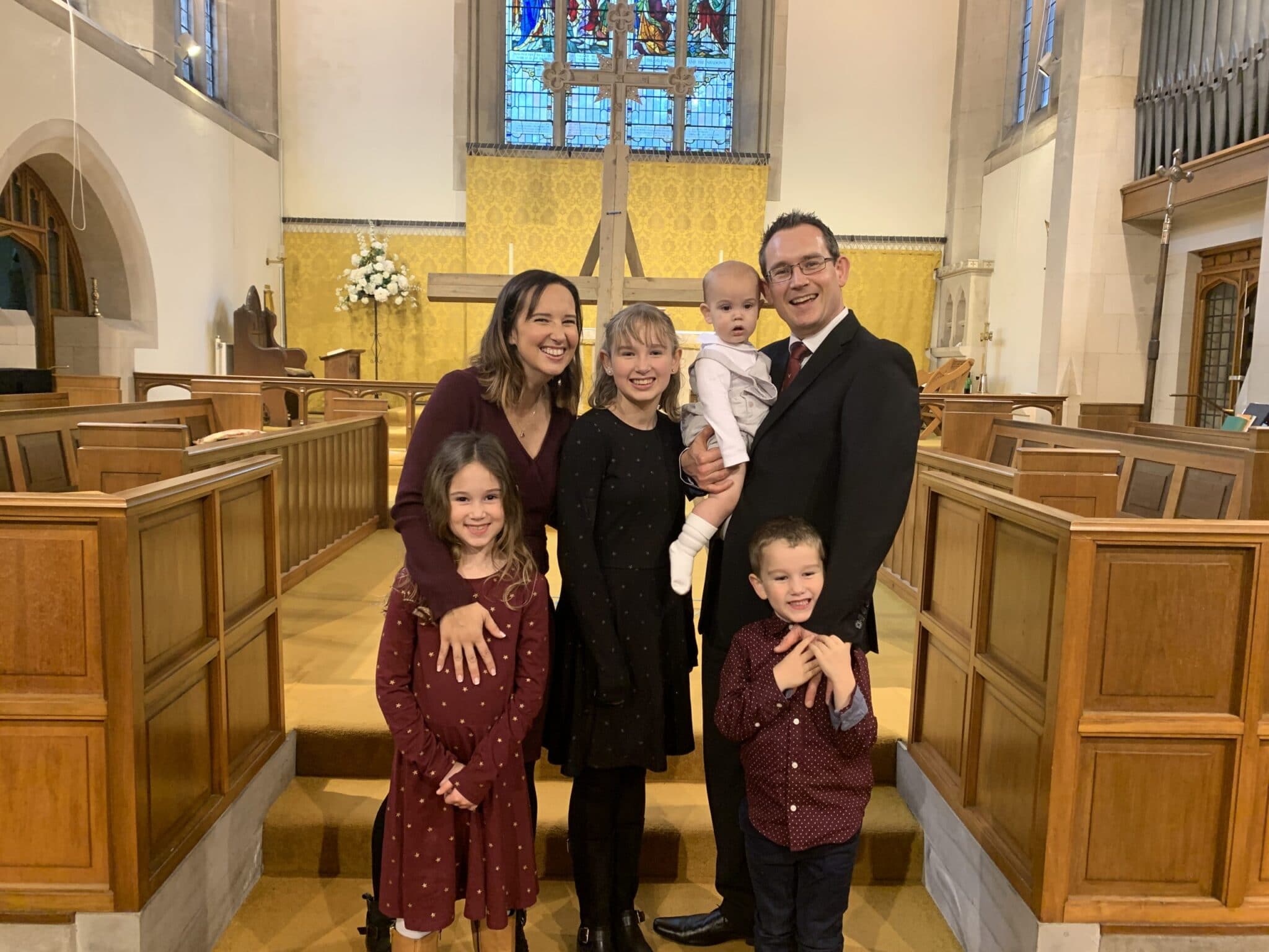 photo of a family of 6 at a baptism in church
