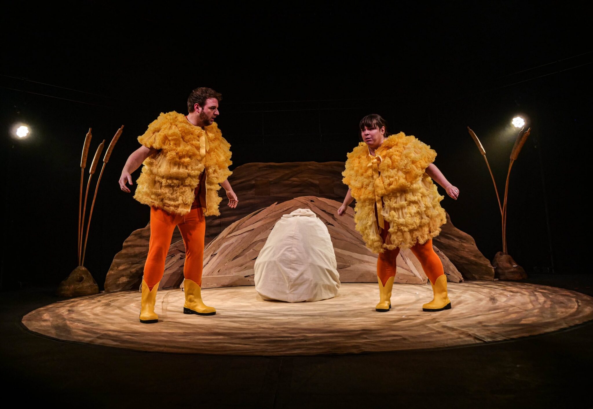 two people dressed as chicks and an egg on stage in the performance of the ugly duckling at the sherman theatre cardiff