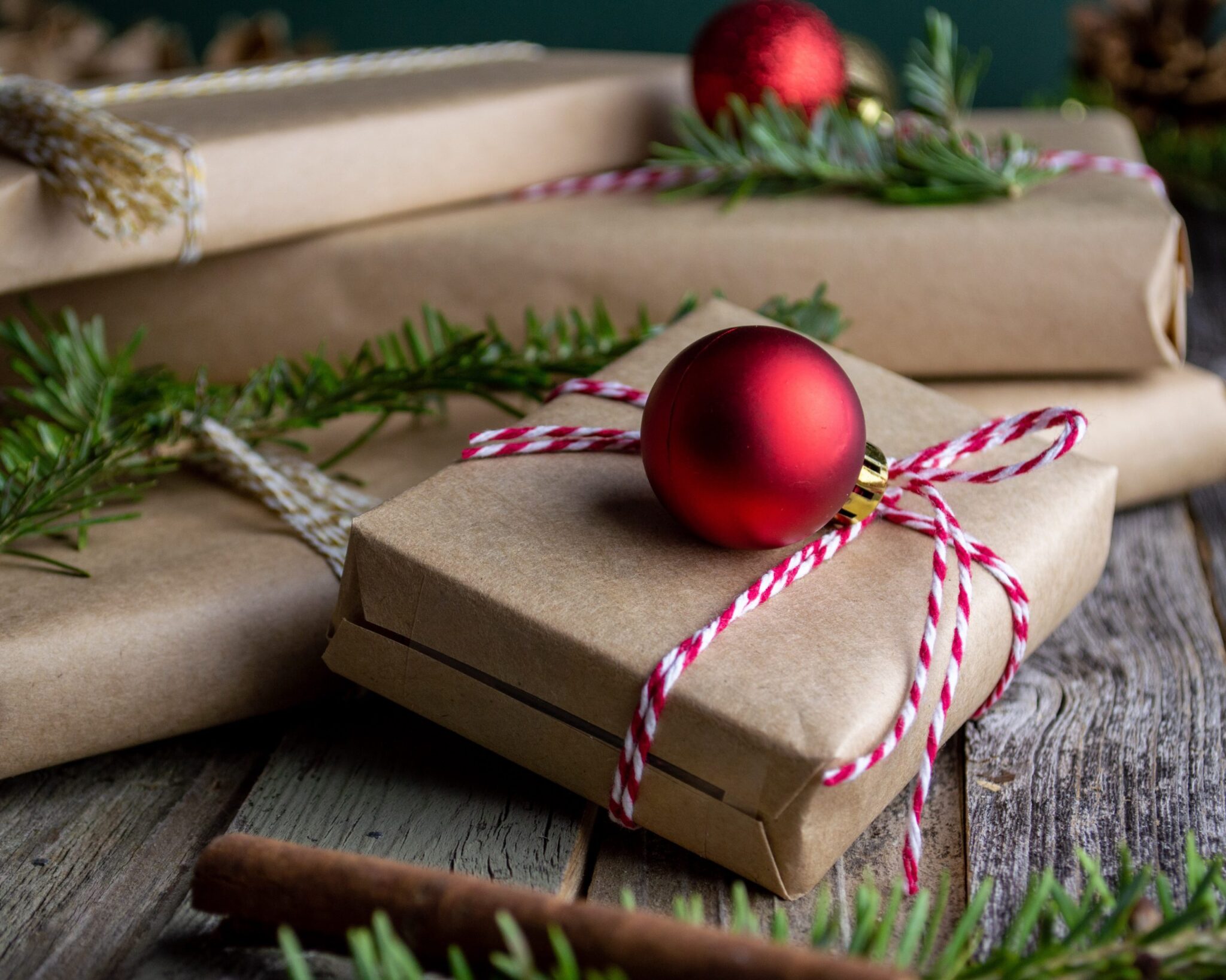 presents wrapped in brown paper with red string and a bauble decoration