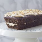 vegan coffee and walnut loaf cake on a cake stand