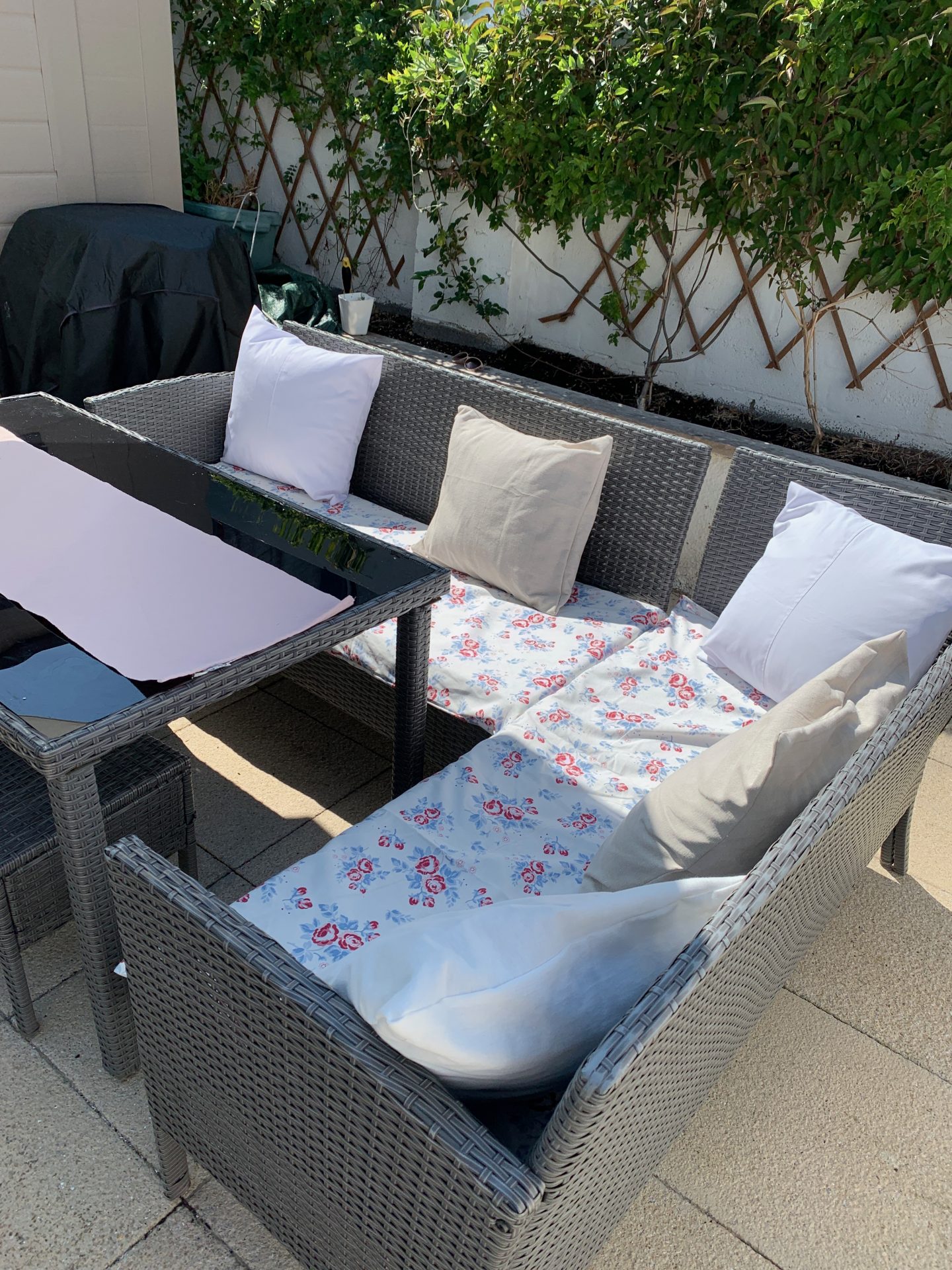 outdoor sofa set with handmade seat pads and cushion covers in a floral fabric.