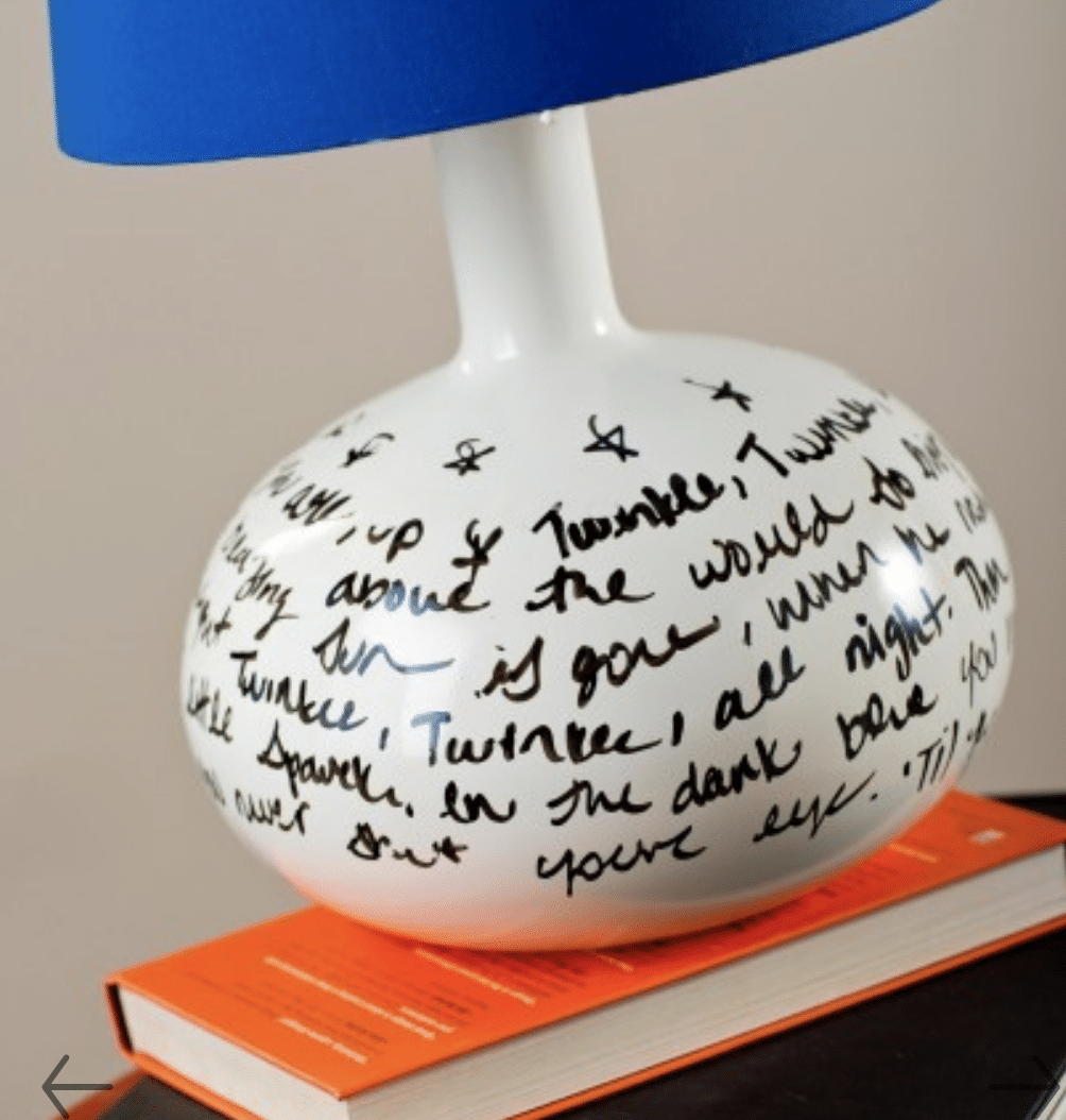 a lamp base with a blue shade. the bottom of the lamp has been painted with whiteboard paint and has twinkle twinkle little star lyrics written on it with a black pen
