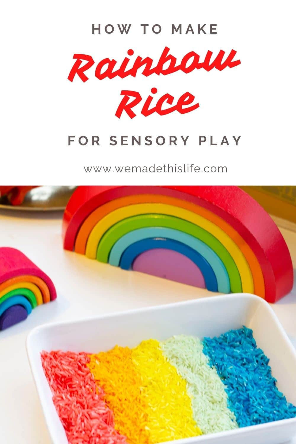 coloured sensory rice in a white dish, arranged in a rainbow pattern with wooden rainbows in the background