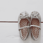 How To Paint Floorboards White (Step by Step Guide) A pair of silver shoes with hearts painted on them.