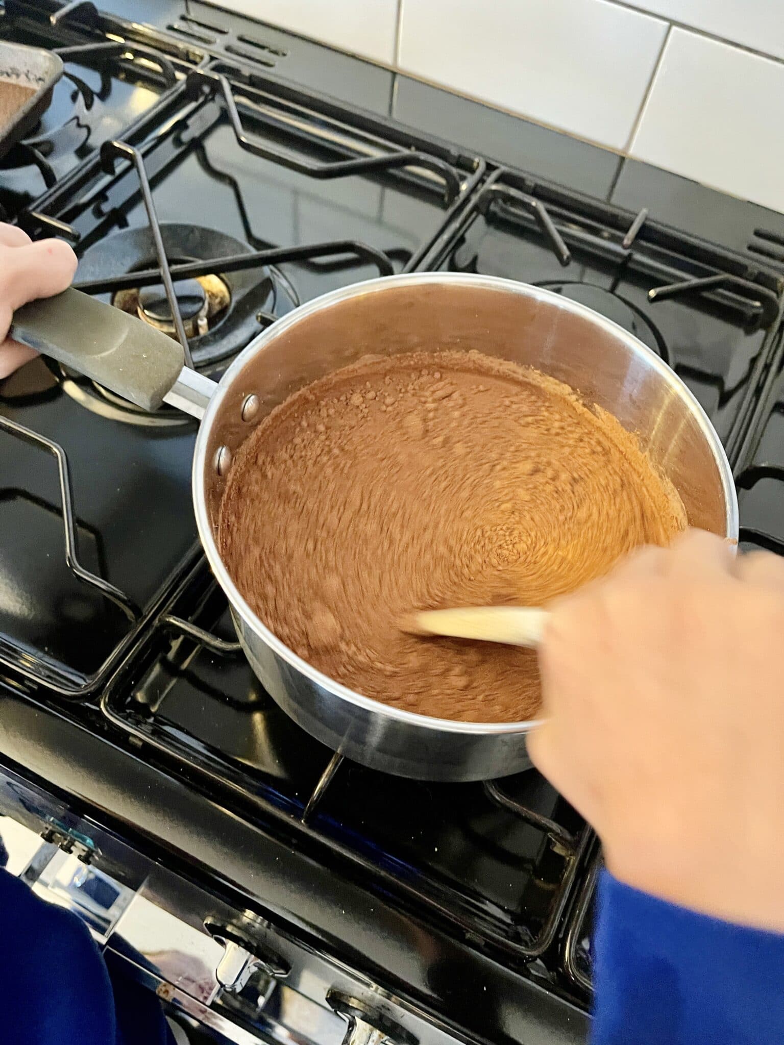 chocolate porridge being stirred on the hob