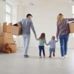 A family moving into a new home, following their detailed moving checklist.