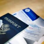 A passport and a Green Card on a table.