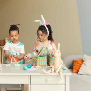 Two children doing Easter crafts.