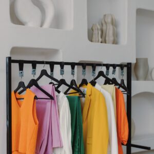 colourful clothes hanging on a clothes rail.