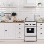 A stylish white kitchen with sleek shelves.