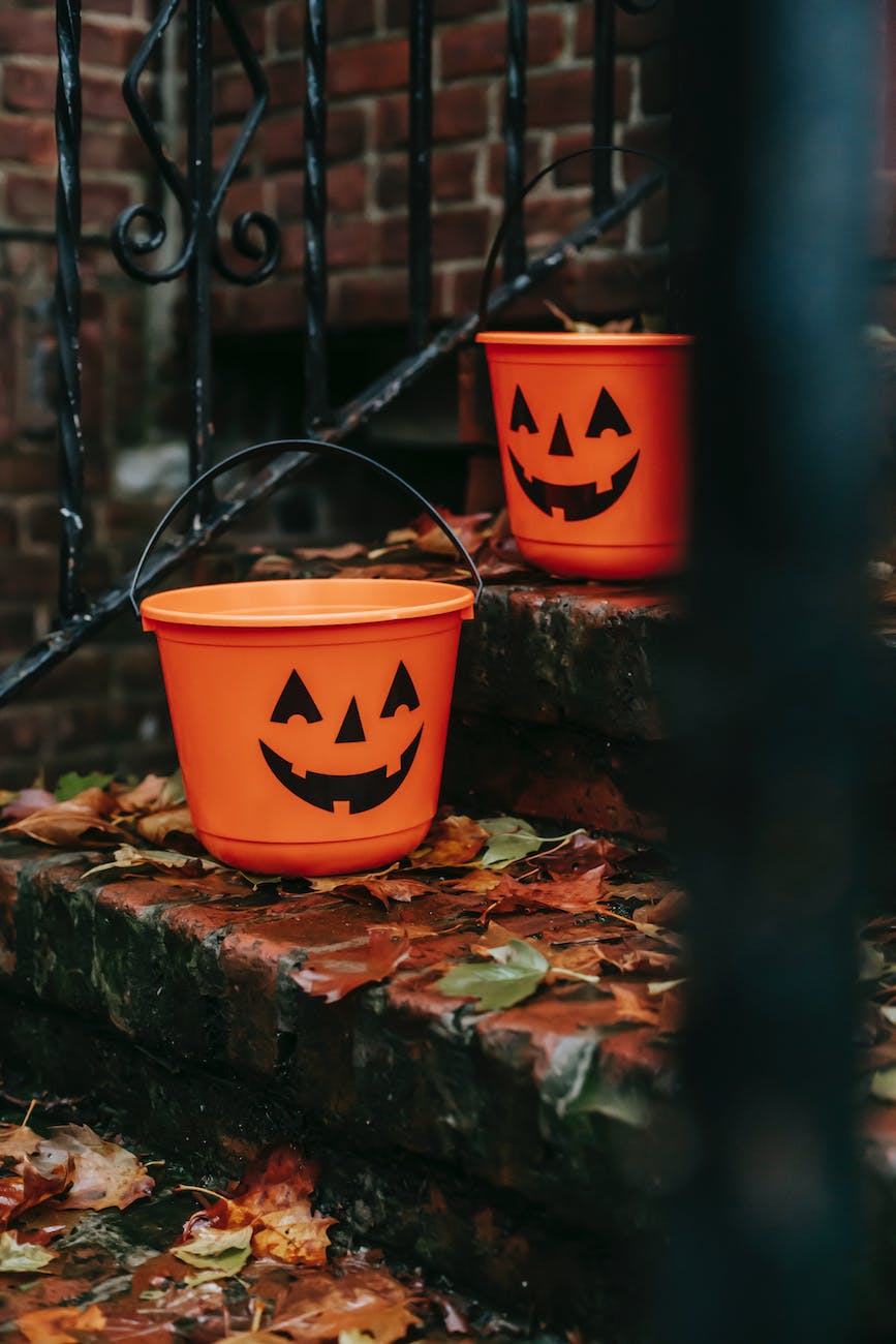 orange buckets with halloween symbols outside house