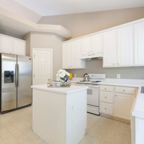 white modern kitchen with large silver fridge