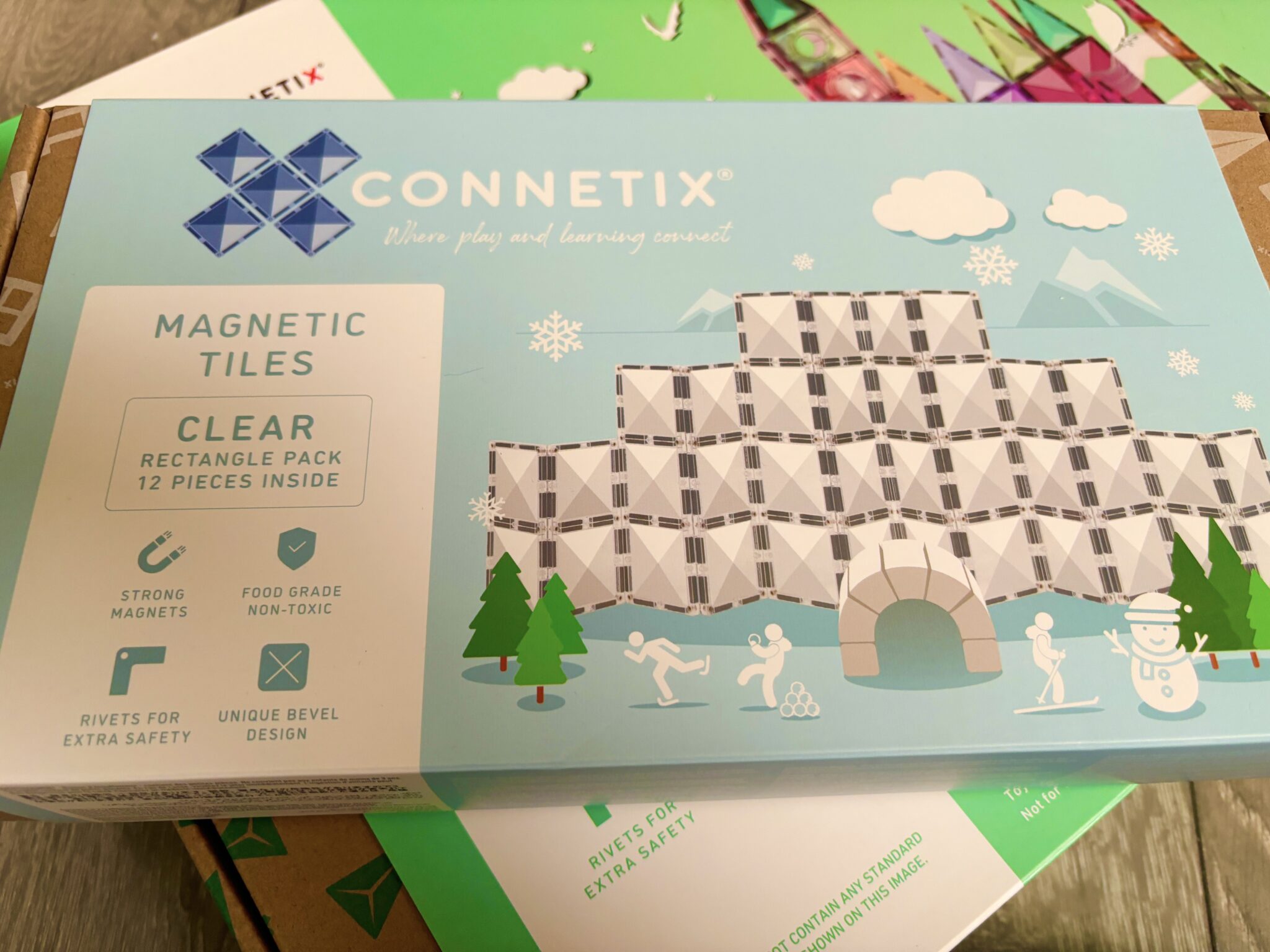A box of connetix magnetic tiles on a table.