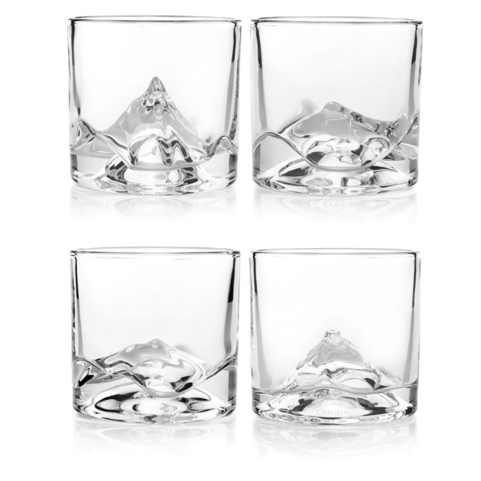 A set of four glasses with a design on them.