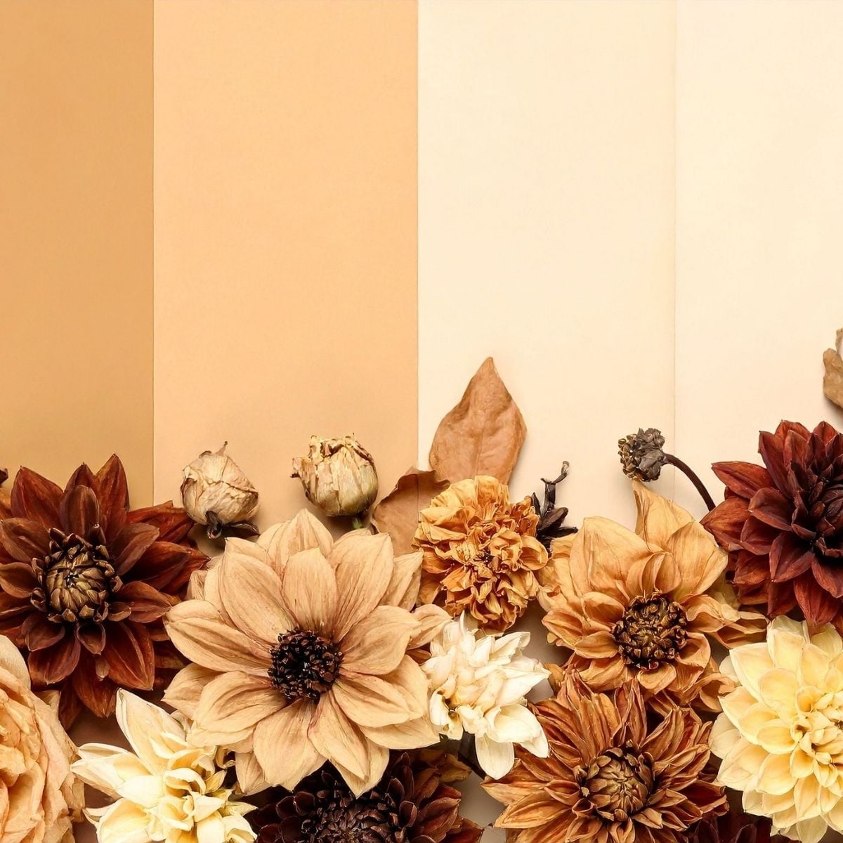How to Wear Autumn Clothing Colours (and Build Outfits You’ll Love) Arrangement of dried and artificial flowers in Autumnal colours—brown, cream, and yellow—placed against a color-blocked beige and tan background, perfect for adding a touch of seasonal fashion to your wardrobe or home décor.