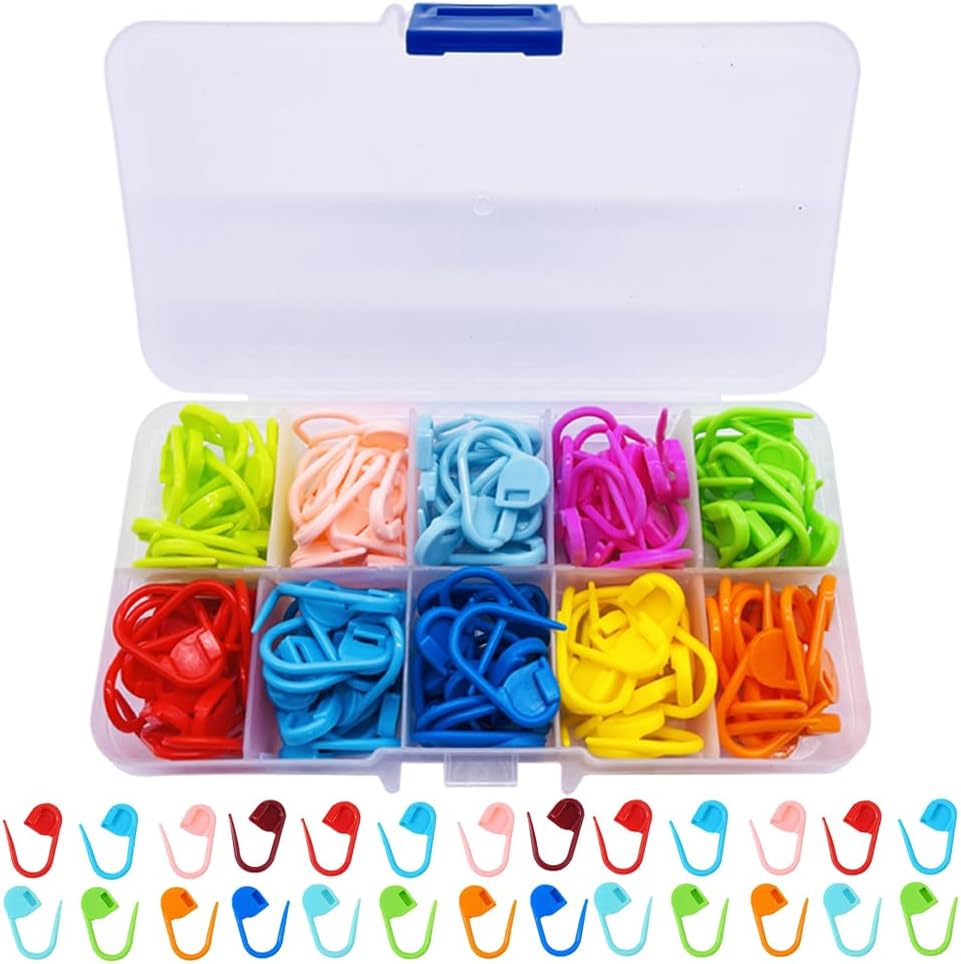 A plastic organiser box with twelve compartments, each filled with colourful plastic stitch markers-essential knitting accessories-displayed neatly in the box and arranged in a row underneath. A must-have knitting tool for every crafter.