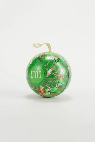 A green Christmas ornament with festive patterns, a gold hanging ribbon, and the word "ETNO" printed on it, perfect for pairing with tin box designs. Set against a plain white background.
