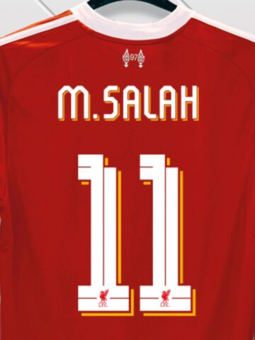 A red Liverpool FC football jersey with "M. Salah" and the number 11 printed on the back in white and yellow text-perfect for Reds fans looking ahead to Winter 2025.
