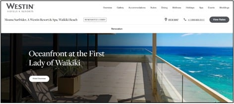 A hotel balcony with seating overlooks the ocean and blue sky at the Westin Moana Surfrider, Waikiki Beach.