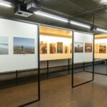 Experience a photography exhibition in a modern indoor space, featuring framed photographs displayed on white panels under ceiling lights-showcasing easy display solutions ideal for exhibitions.