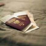 Two Italian passports and boarding passes rest on a textured fabric surface-perfect for travel tips or anyone preparing documents for a UK Civil Partnership Visa with overseas partners.