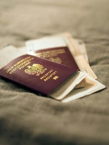 Two Italian passports and boarding passes rest on a textured fabric surface-perfect for travel tips or anyone preparing documents for a UK Civil Partnership Visa with overseas partners.