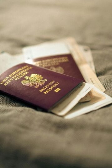 Two Italian passports and boarding passes rest on a textured fabric surface-perfect for travel tips or anyone preparing documents for a UK Civil Partnership Visa with overseas partners.