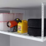 A metal storage shelf holds clear plastic bins, a red and black utility torch, a yellow petrol container, and two stacked car tyres-perfect for those looking to declutter home and keep family clutter under control.