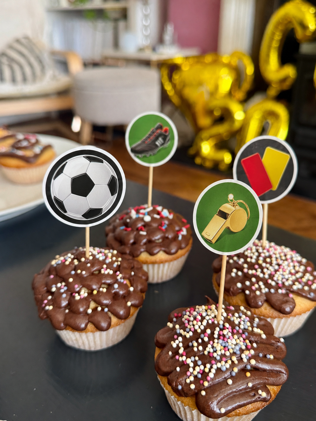 How To Host A Football Watch Party At Home This Summer Perfect for a football viewing party, these chocolate cupcakes are topped with colourful sprinkles and football-themed decorations—balls, boots, whistles, red/yellow cards. Balloons in the background add to the fun atmosphere you can enjoy at home this summer.