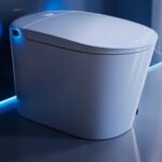 A modern, sleek white smart toilet with soft blue LED lighting, set against a glossy, minimalist bathroom wall-perfect inspiration for your smart bathroom or next toilet buying guide.