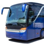 A blue coach with large windows is parked on a paved surface, photographed from the front left side against a white background-ideal for group travel or coach hire in Newcastle.