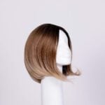 A short brown ombré wig displayed on a white mannequin head against a plain light background.