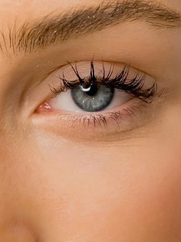 Natural Eye Care: What to Know About Using Castor Oil Around the Eyes Close-up of a light-skinned person's blue eye, showing detailed eyelashes, eyebrow, and smooth skin-an ideal image to highlight the benefits of Castor Oil for natural eye care.